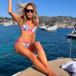 Amanda Holden, 53, flaunts her incredible physique in colourful bikini as she balances on the side of a boat in latest Instagram post
