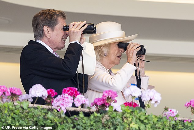 Racing manager John Warren and Queen Camilla (both pictured) watch the racing through binoculars