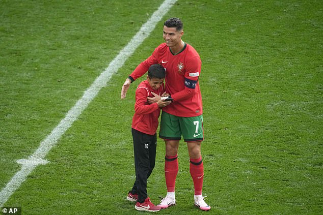 Cristiano Ronaldo poses for selfie with young fan during Portugal’s win over Turkey at Euro 2024 but frustrated superstar rejects FOUR more requests from pitch invaders, sparking security concerns