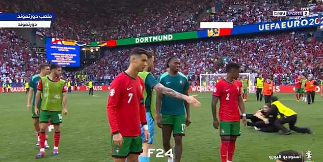 Ronaldo looked unimpressed as a fifth pitch invader tried to get close to him after the match