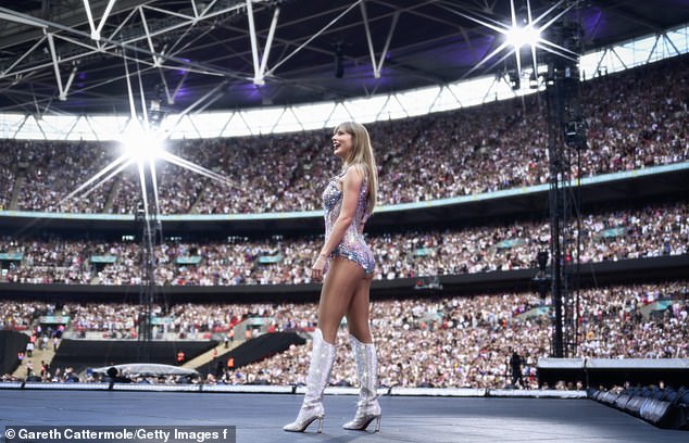 Taylor smiles as the crowd at Wembley cheers tonight