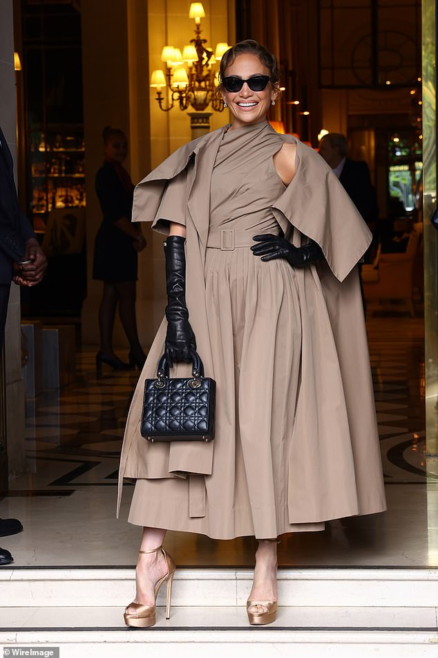 Jennifer Lopez puts on a brave face at Dior PFW show but hides her hands under leather gloves after husband Ben Affleck ditched his wedding ring amid mounting divorce speculation