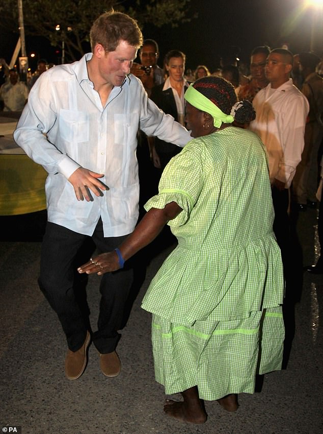 Prince Harry certainly isn't afraid of the dancefloor - as his wedding reception proved. But he also showed off his skills during his tour of the Caribbean and Brazil in 2012. Above: Dancing with a local woman in Belize