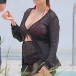 Kourtney Kardashian, 45, is a busty beauty as she flaunts her post-baby body while on the beach in Miami with husband Travis Barker