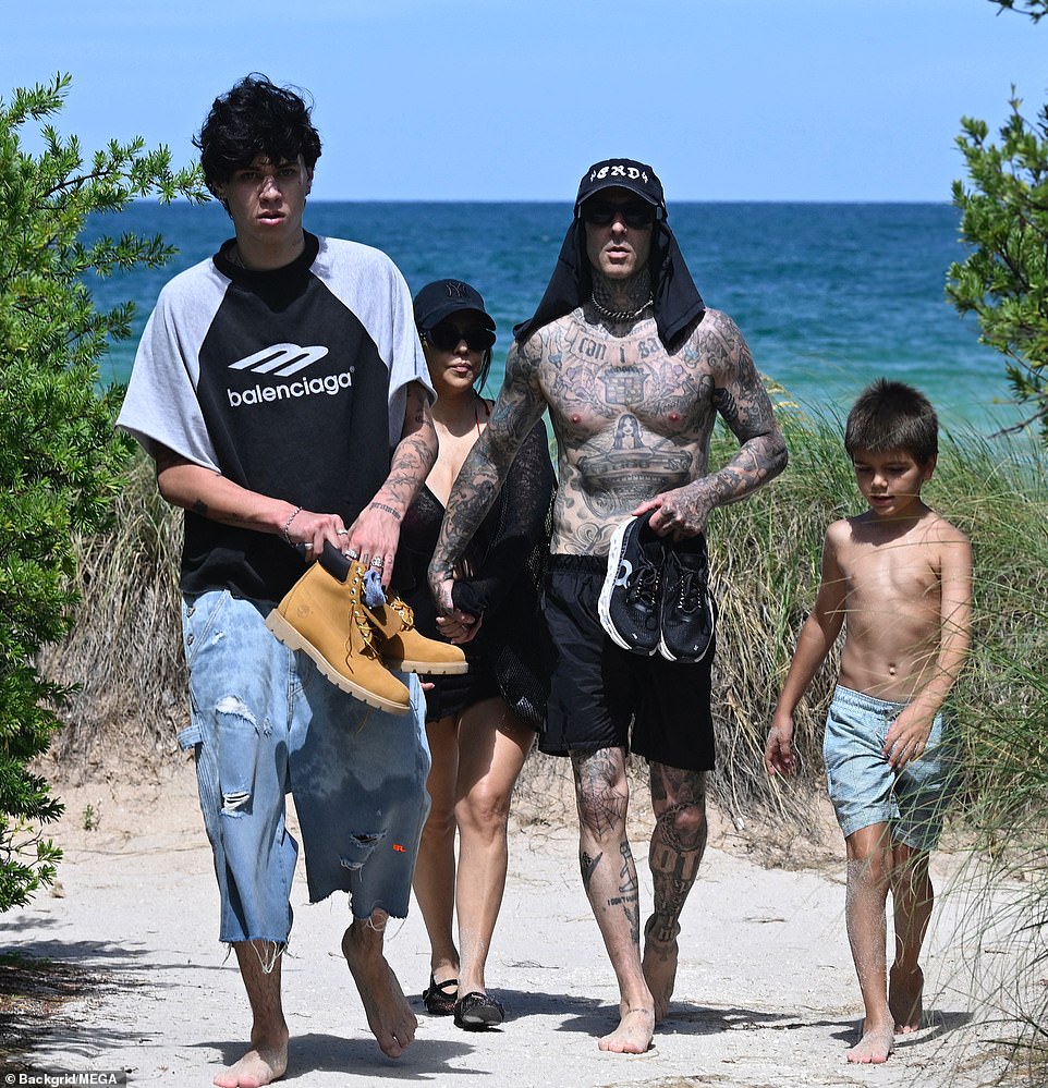 There were several friends around the power couple as they worked on their suntans on the white sand beach. And his son Landon Barker, whose mother is Playboy model Shanna Moakler, was also seen