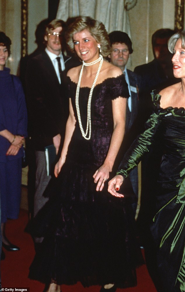 Princess Diana in Hamburg, Germany, in 1987 wearing a black silk lace off-the-shoulder gown by Victor Edelstein layered over deep magenta silk. The dress is expected to sell for up to $400,000