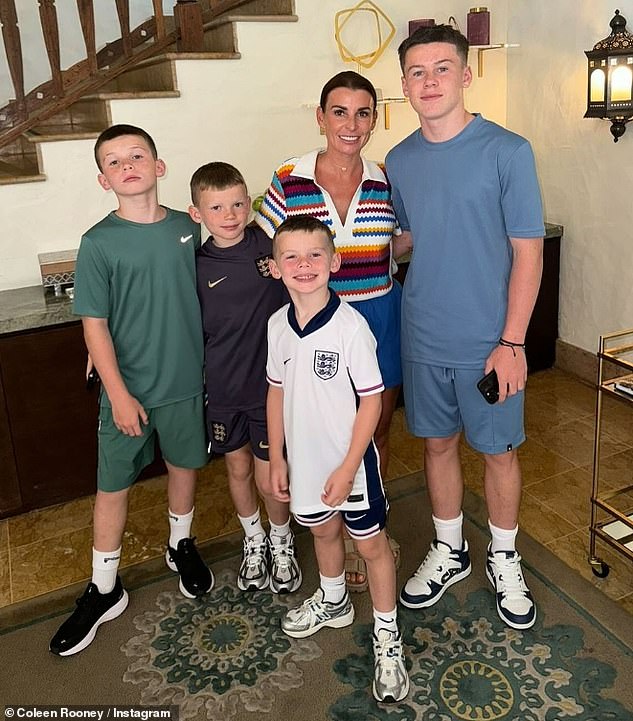 Coleen Rooney proudly poses with her four sons as the family show their support for England following their Euros clash against Slovenia