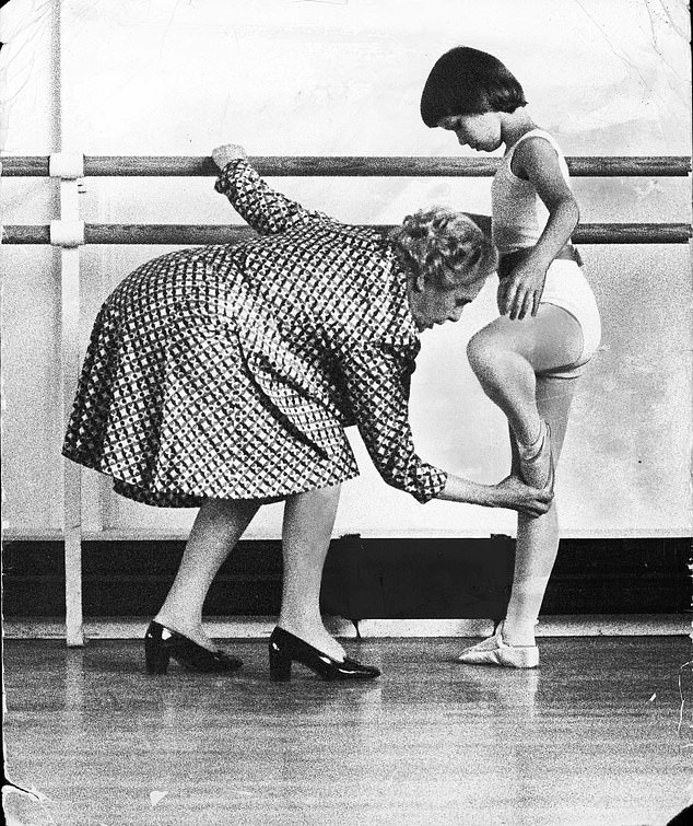 Dame Ninette de Valois corrects Lady Sarah's position during her lesson with the dance statue