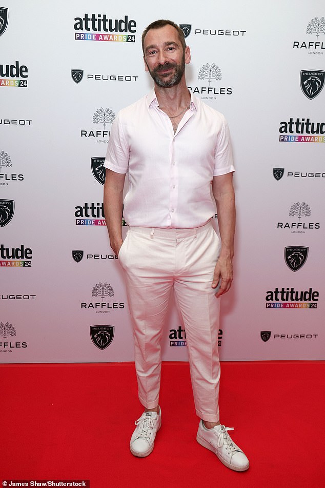 Actor Charlie Condou went simple with a plain pink shirt paired with white trousers and casual trainers
