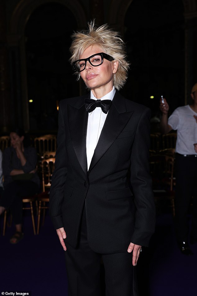 Her newly dyed, platinum blonde hair was styled into messy spikes, and Lisa also wore black-framed glasses