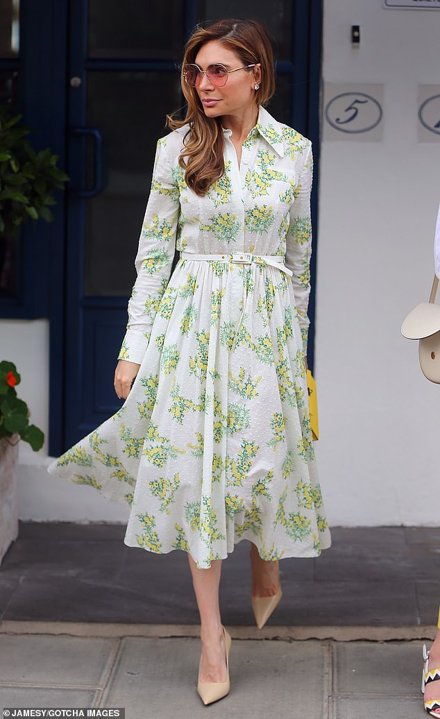 Robbie Williams' wife Ayda Field wore a white, green and yellow patterned dress and accentuated her body with beige court heels.