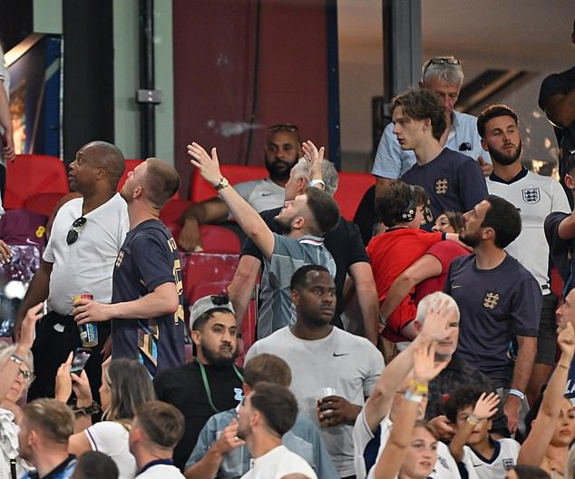 Family members of England players were left drenched as fans threw beer cups at them after draw with Slovenia