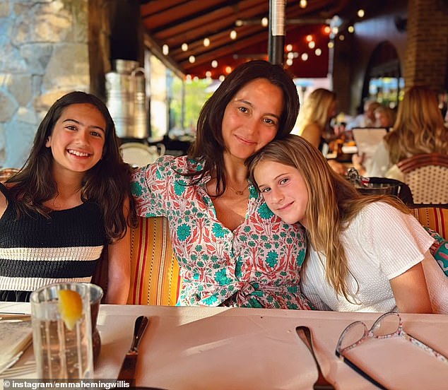 Emma is pictured with the couple's daughters Mabel (12) and Evelyn (9)