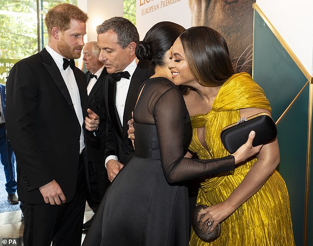 The Duchess of Sussex was spotted hugging Beyoncé at the European premiere of Disney's The Lion King at Odeon Leicester Square in London, with Prince Harry standing behind them.
