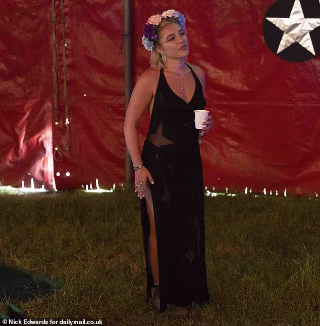 Florence showed off her fun festival fashion sense in the plunging black gown teamed with lace-up boots