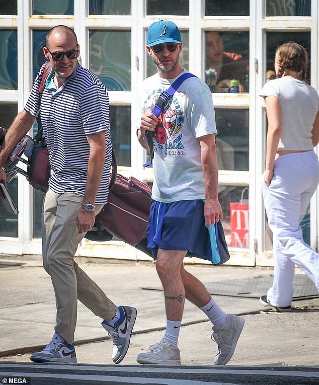 Justin dressed down in the summer heat by donning a vintage, Grateful Dead shirt as well as a pair of navy shorts