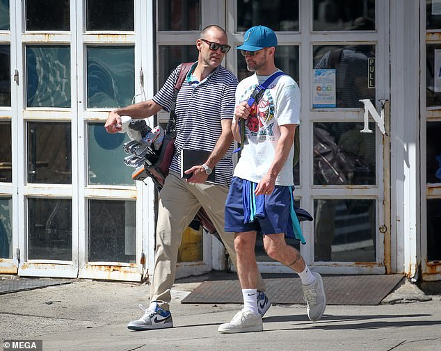 Timberlake was seen strolling through the bustling city streets and was joined by another individual who carried a golf bag