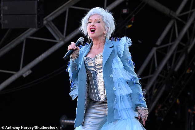 Cindy looked incredible for the afternoon performance as she wore a silver corset with a pair of matching trousers and a ruffled blue long coat