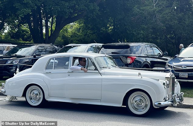 The vehicle in which the newlywed couple travelled was a white Rolls Royce car