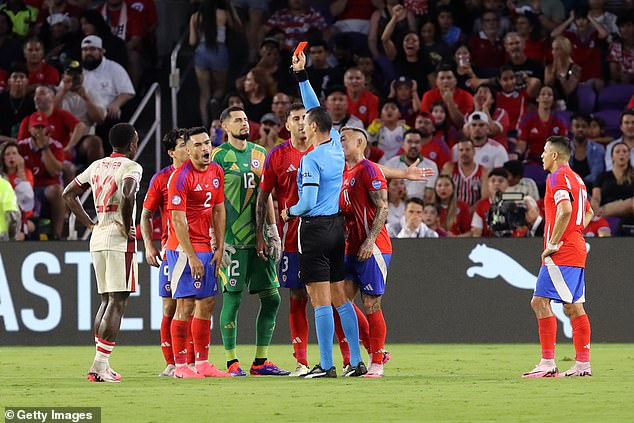 Referee Jesus Valenzuela shows Chile's Gabriel Suazo a red card in the first half in Orlando