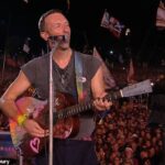 Whoever got knighted wearing shorts! Coldplay’s Chris Martin honours wheelchair-bound Glastonbury founder Sir Michael Eavis, 88, in touching on-stage tribute before inviting Michael J Fox to join him playing guitar on Fix You amid his Parkinson’s battle