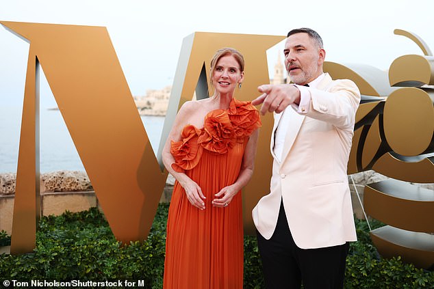 Sarah, 51, made sure all eyes were on her as she arrived in an orange one-shoulder satin gown with a floral ruffle at the neckline.