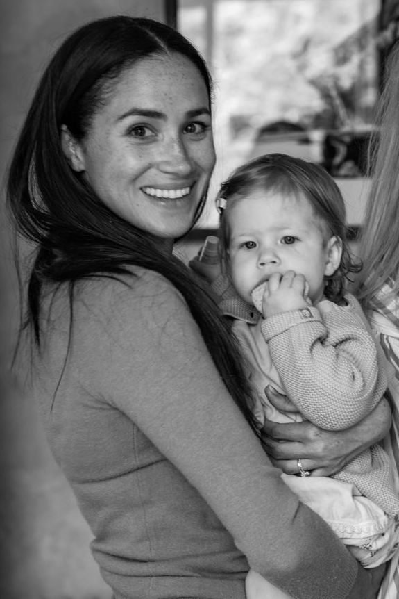 Meghan Markle holds daughter Lilibet during her first birthday party