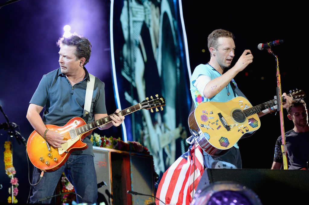 Actor Michael J. Fox (left) performs onstage with Coldplay recording artist Chris Martin 