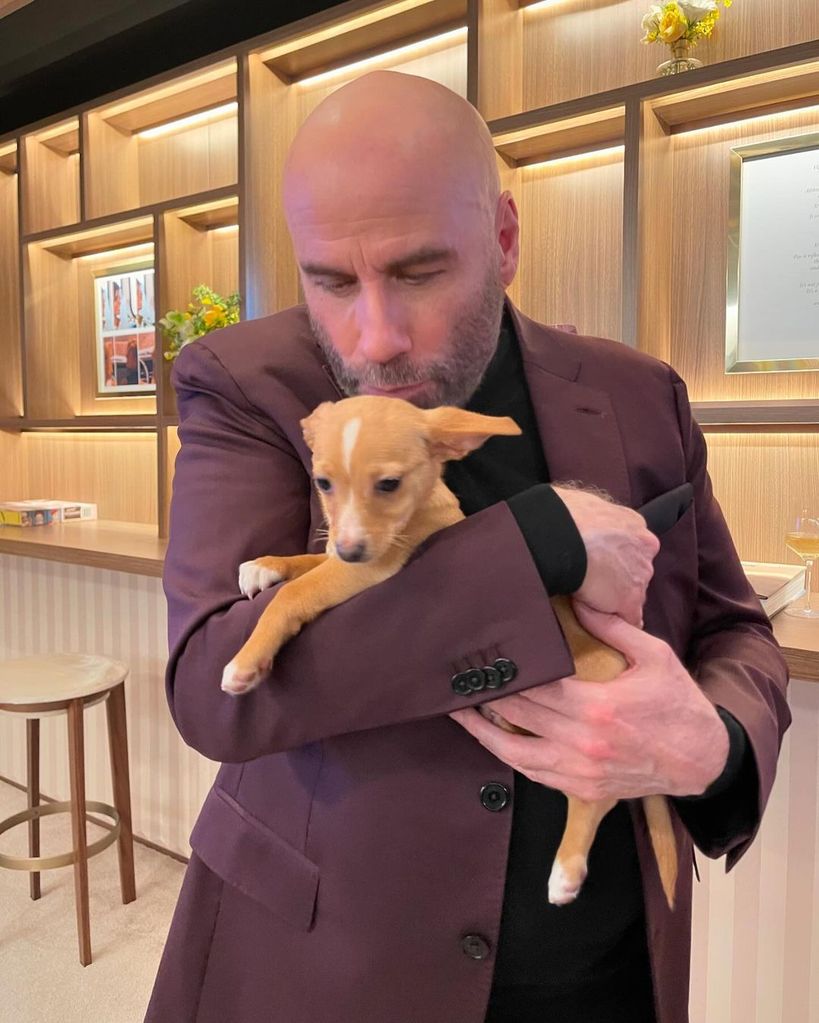 John Travolta with his puppy Peanut at the 2022 Oscars