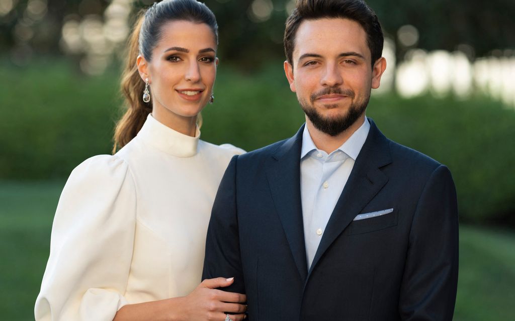 Jordan's Crown Prince Hussein wearing a suit and his fiancée Rajwa Al Saif wearing a white dress.