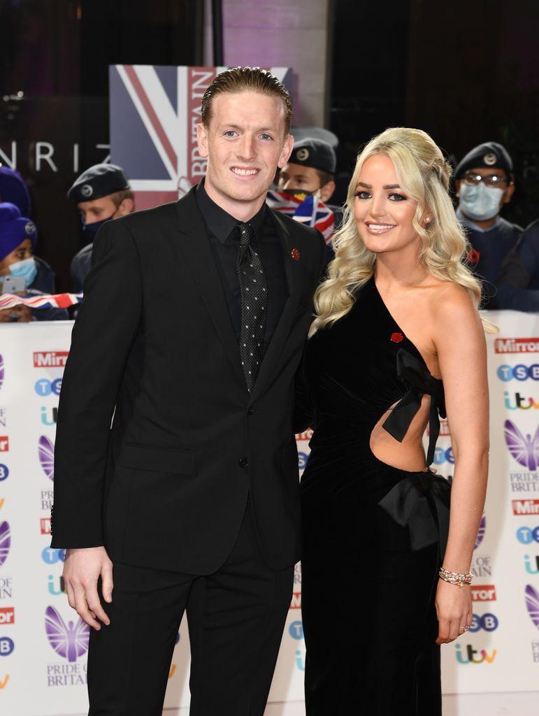 couple wearing black tie on the red carpet