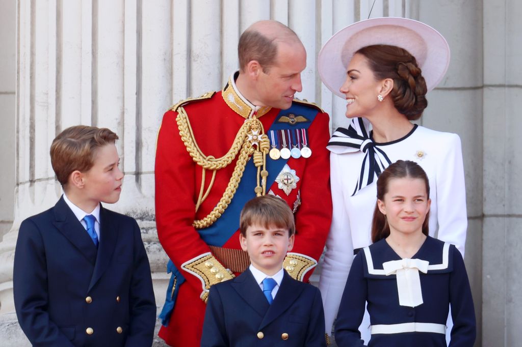 Prince William and Kate Middleton looking at each other - they are accompanied by Prince George, Prince Louis and Princess Charlotte