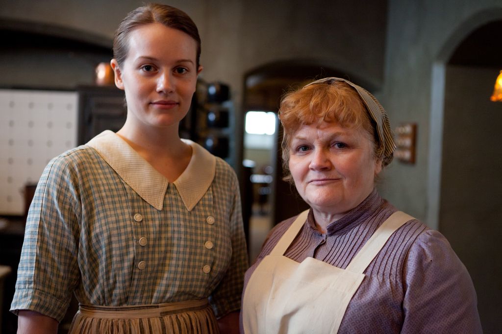 Cara Theobold stars as Ivy Stuart and Lesley Nicol stars as Mrs. Patmore in Downtown Abbey
