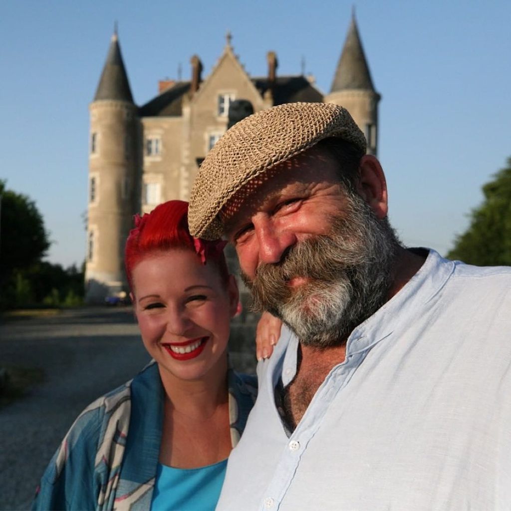 Angel and Dick Strawbridge posing in front of the Chateau de la Motte Husson