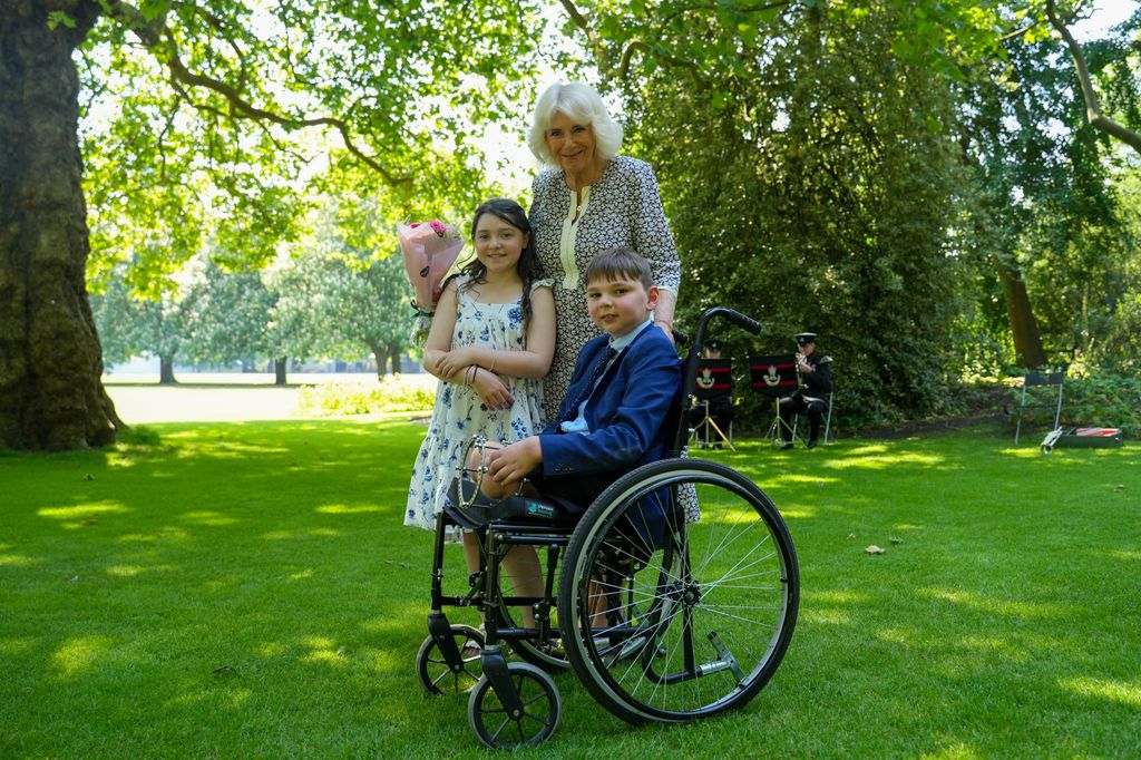 Queen Camilla with a little girl and a little boy in a wheelchair