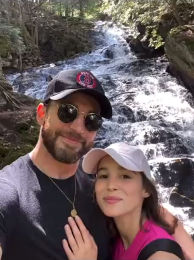 Chris Evans and Alba Batista pose for a selfie in front of a waterfall