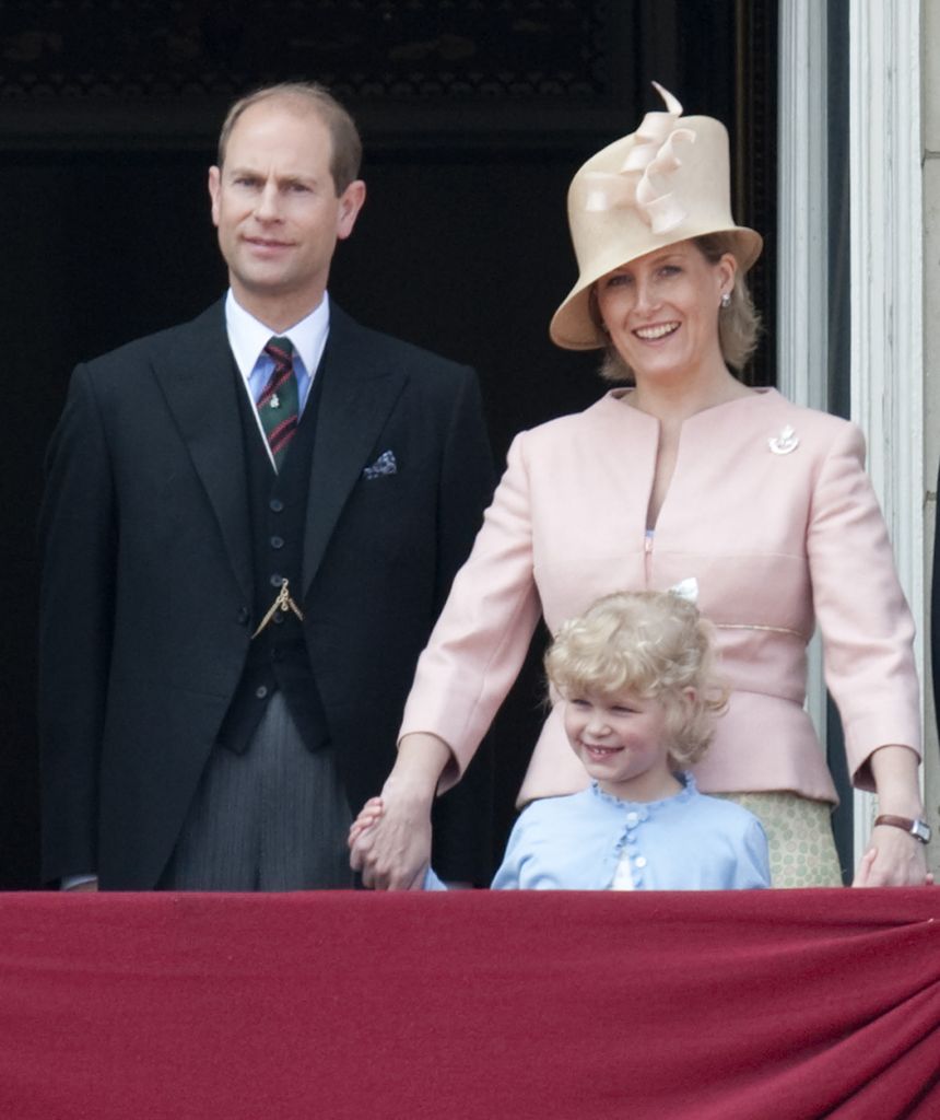 Lady Louise smiles on the balcony with Edward and Sophie