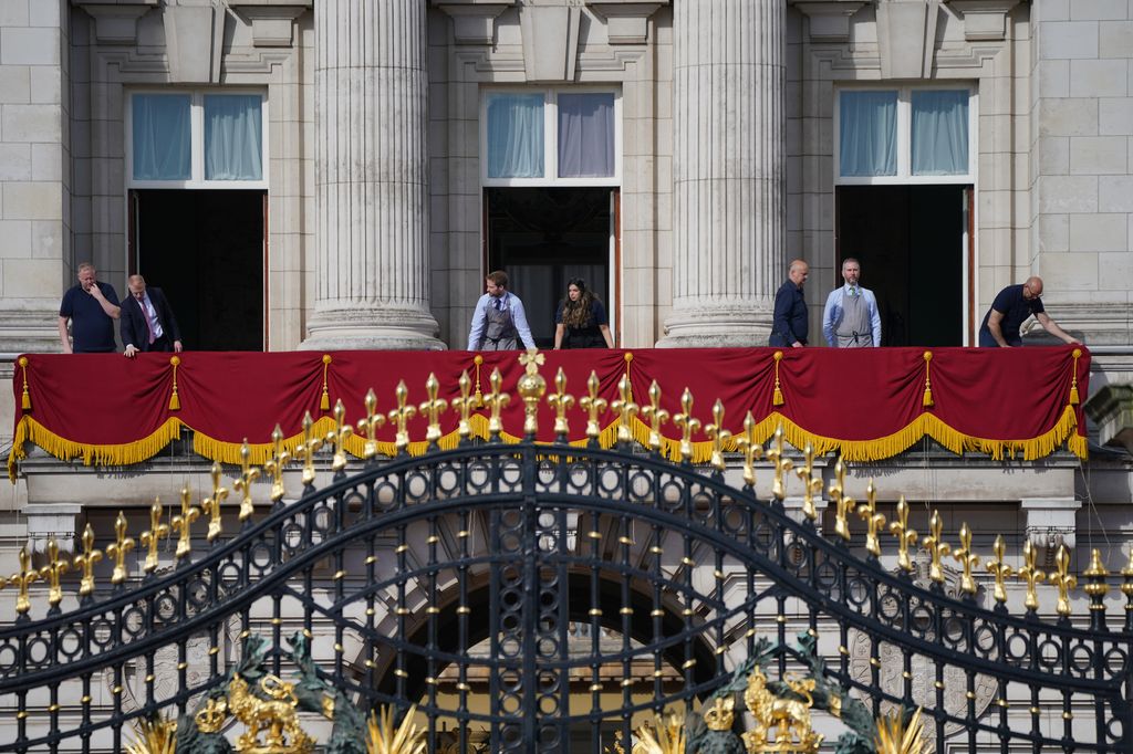 Royal family staff prepare the balcony at Buckingham Palace in London