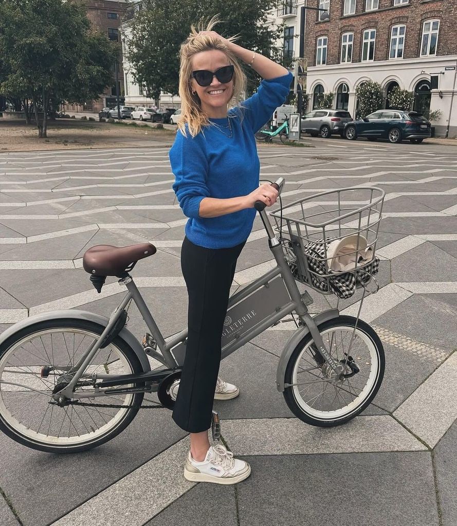 Reese Witherspoon rides a bike in Denmark wearing Autry sneakers
