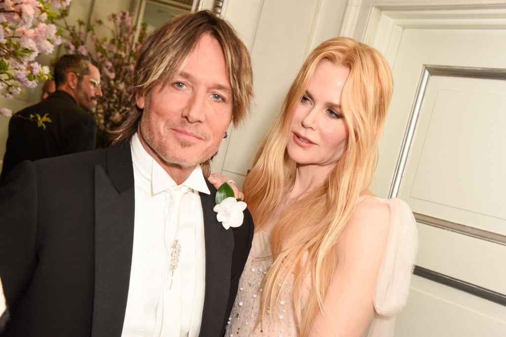 Keith Urban in a suit and Nicole Kidman in a bright nude pink dress