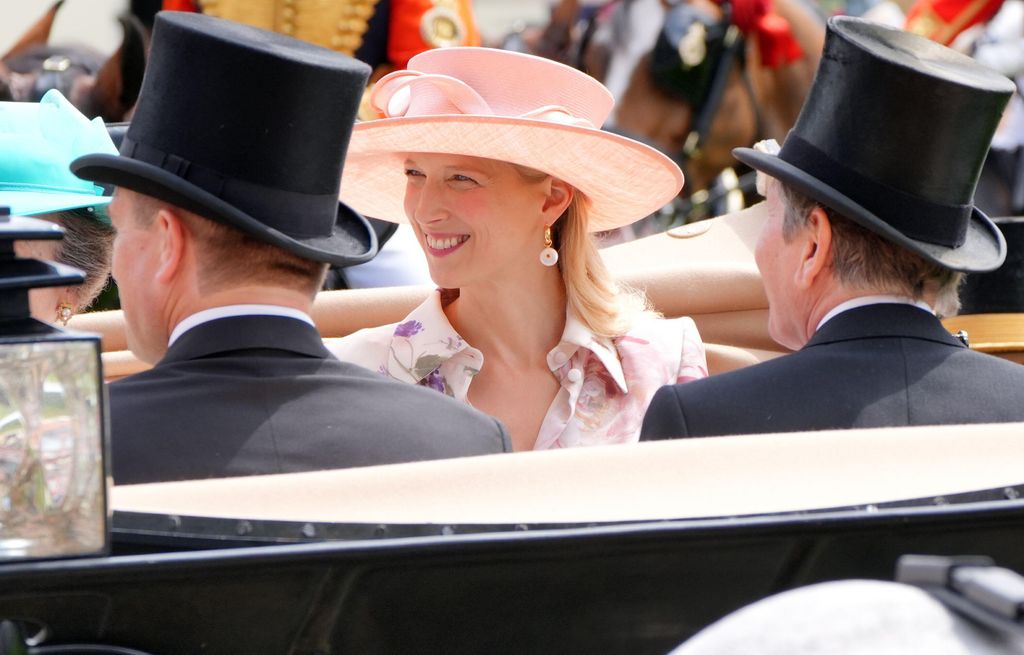Lady Gabriella Kingston smiling in the carriage