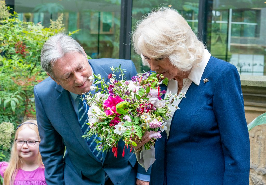 Queen Camilla smells the flowers