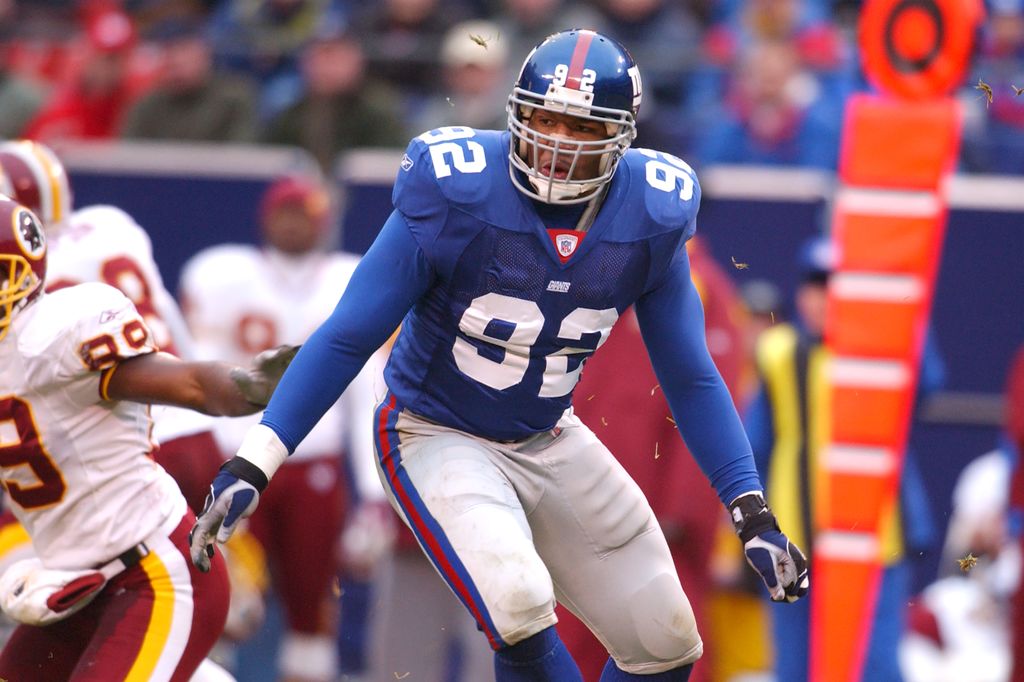 Michael Strahan #90 of the New York Giants in position during an NFL football game against the Washington Redskins on November 17, 2002 at Giants Stadium in East Rutherford, New Jersey