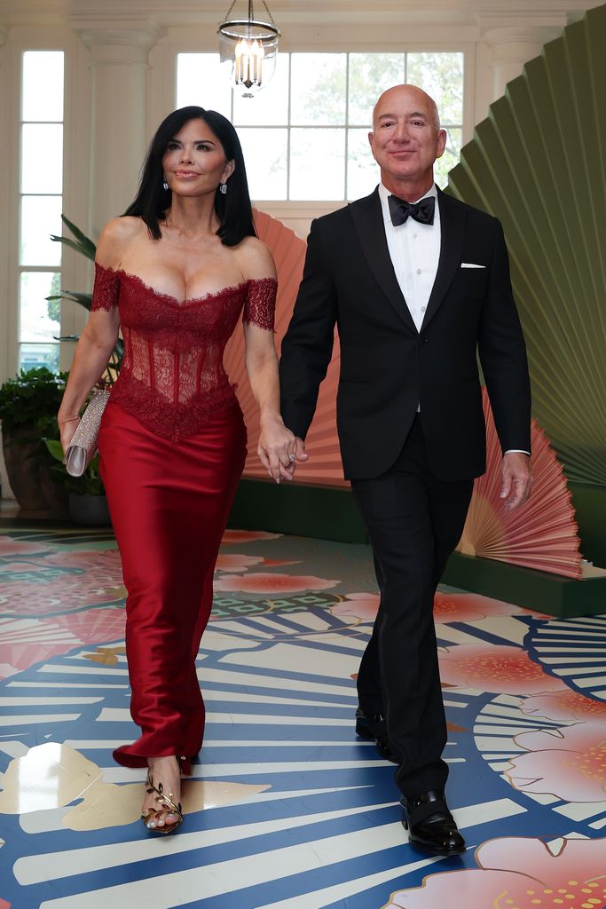 Amazon founder Jeff Bezos (right) and his fiancée Lauren Sanchez arrive at the White House for a state dinner