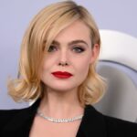 Elle Fanning’s plunging black suit and red lip is giving major SHE-E-O vibes