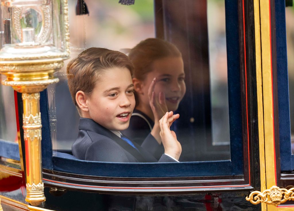 Prince George and Princess Charlotte of Wales shake hands during Trooping the Colour 2024 