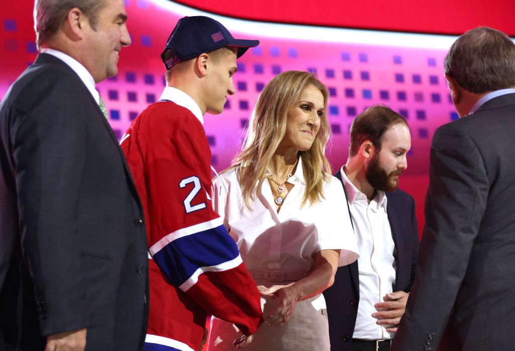 Ivan Demidov shakes hands with Celine Dion on stage after being selected fifth by the Montreal Canadiens