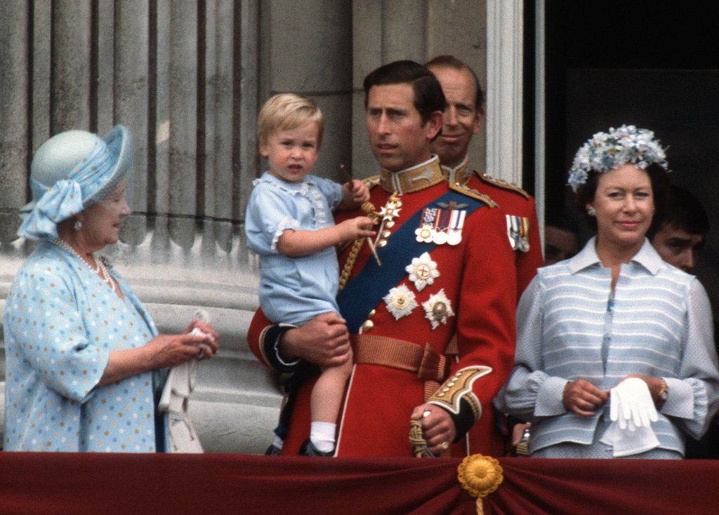 Prince Charles holding William on the balcony