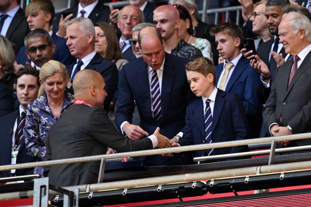 Prince George of Wales shakes hands with Pep Guardiola