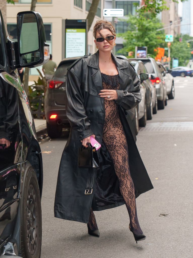 Hailey wore a stunning lace catsuit, leather trench and heels